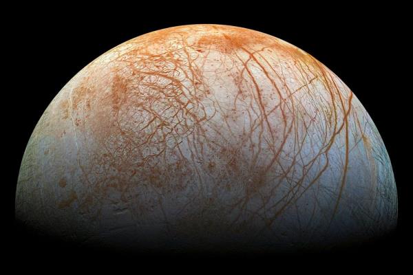 This image shows red streaks across the surface of Europa, the smallest of Jupiter’s four large moons. The discovery of new types of salty ice could explain the material in these streaks and provide clues on the composition of Europa’s ice-covered ocean. Image credit: NASA/JPL/Galileo